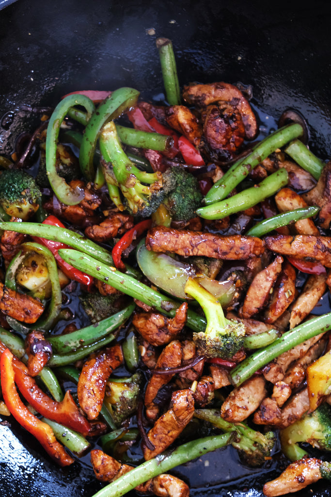 woking stir fry in a cast iron wok