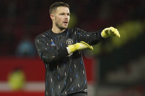 Manchester United's goalkeeper Jack Butland warms up before the English League Cup quarter final soccer match between Manchester United and Charlton Athletic at Old Trafford in Manchester, England, Tuesday, Jan. 10, 2023. (AP Photo/Dave Thompson)